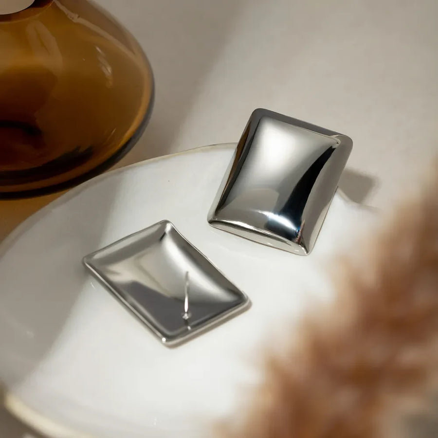 Sculpted silver rectangle earrings with a polished finish.