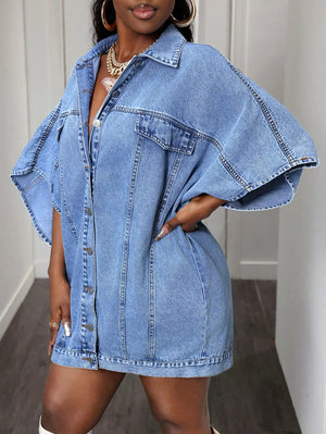 Oversized denim batwing top in medium blue with button front and chest pockets.