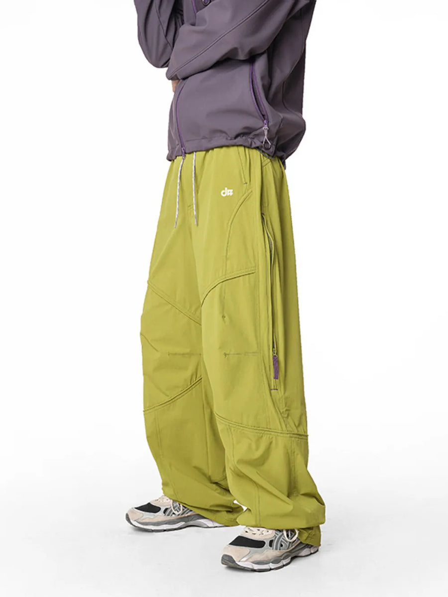 Relaxed fit cargo pants in Mustard Yellow with drawstring and zippered pockets.