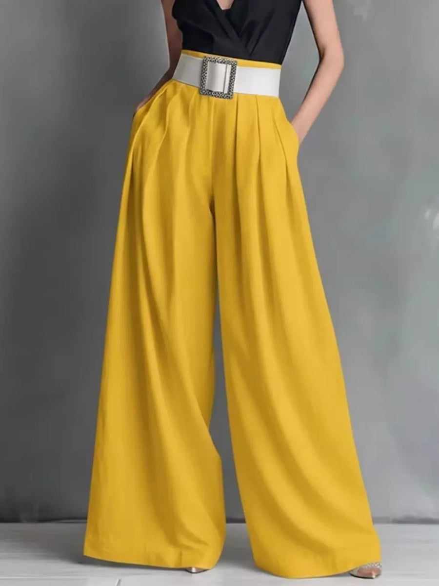 Yellow belted high-waisted wide-leg maternity pants with pockets and a white buckle.