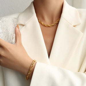 Gold textured rope chain bracelet and necklace set on a model wearing a white blazer.