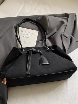 Black suede shoulder bag with leather trim and top handles