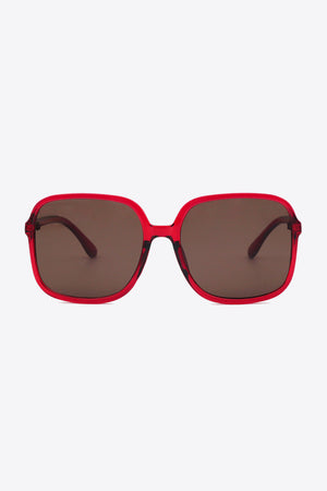 Red square frame sunglasses with brown lenses and bold acetate frames.