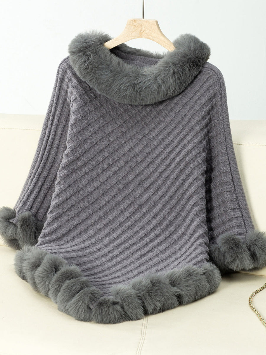 Dark gray knit poncho with faux fur trim on collar, cuffs, and hem
