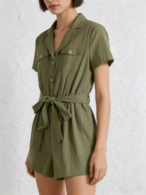 Olive green cotton romper with collared neckline, button-down front, short sleeves, and tie waist.
