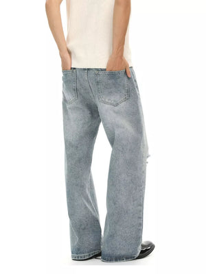 Men's light wash distressed wide-leg denim jeans with a relaxed fit.