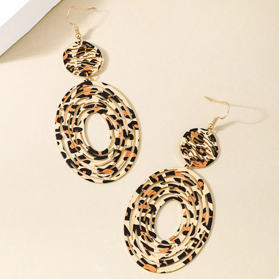 Bold dangle earrings in 18K gold with leopard print pattern.