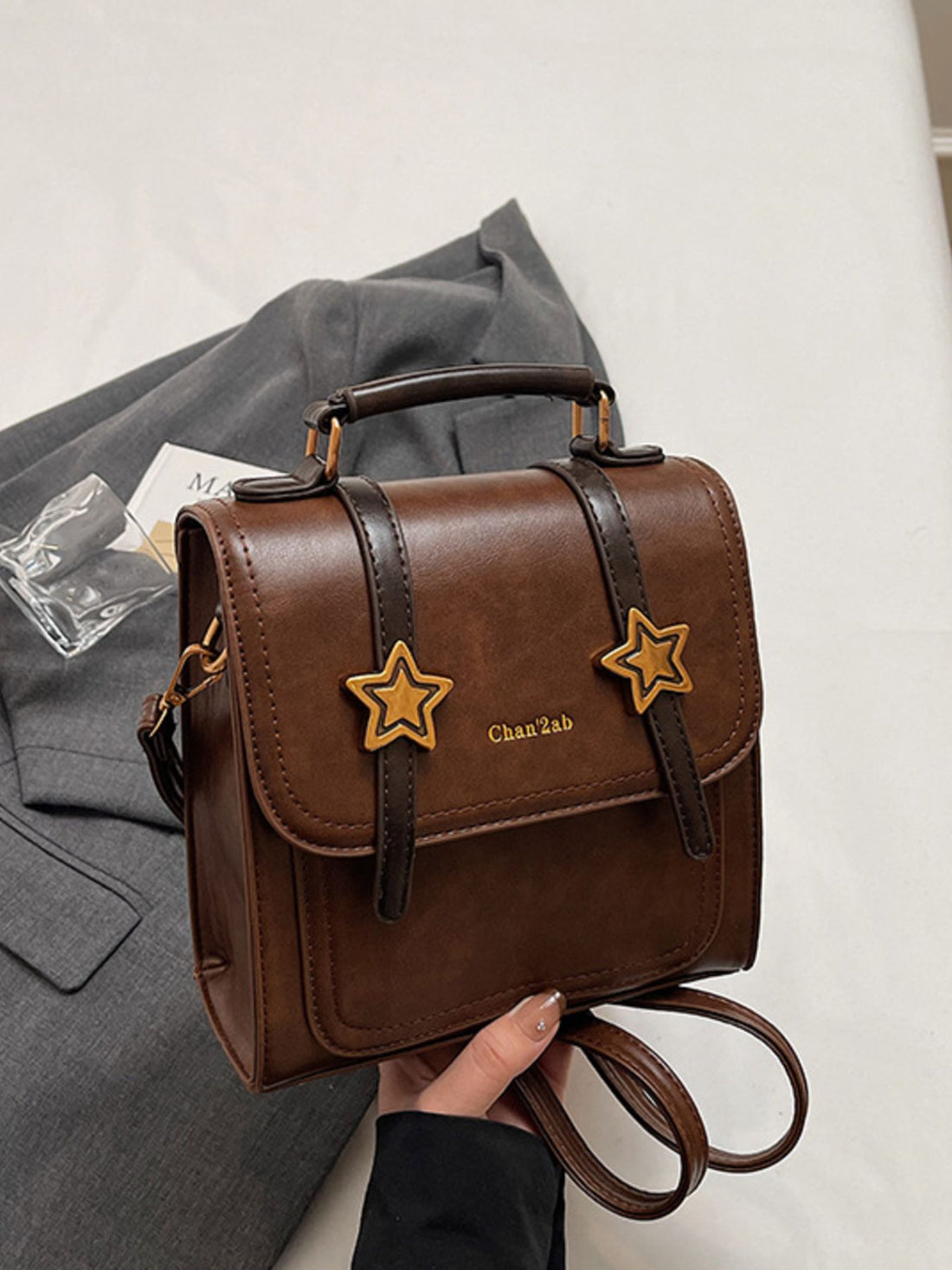 backpack in brown featuring top handle and boxy fit