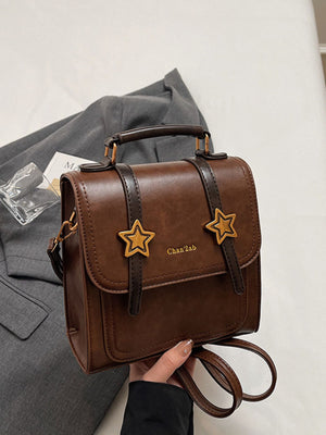 backpack in brown featuring top handle and boxy fit
