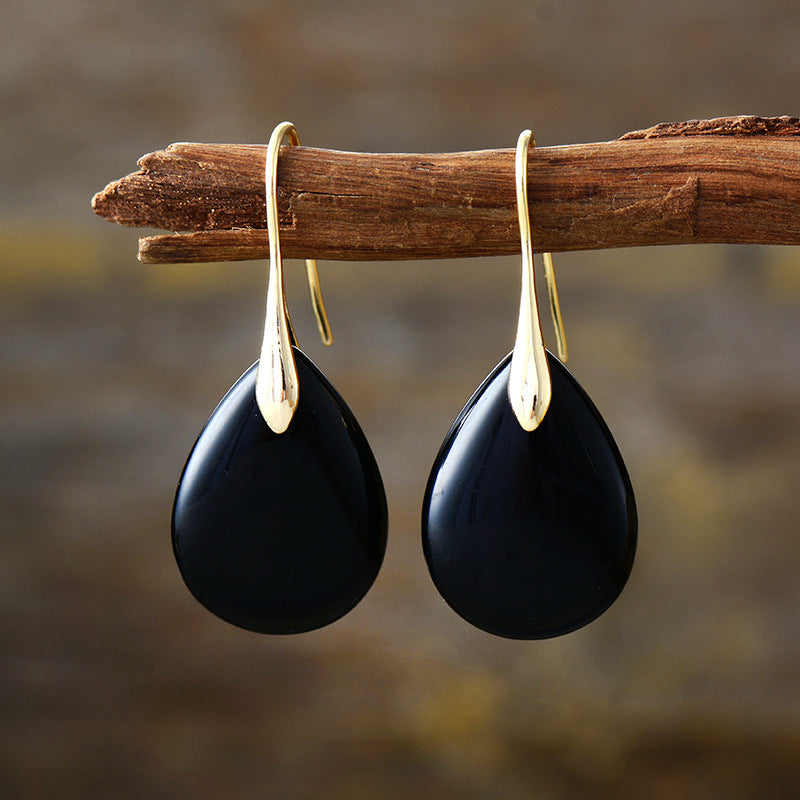 Black gemstone teardrop leverback earrings with gold accents.