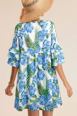 Ruffled mini dress with hydrangea and palm print, featuring tiered flutter sleeves.