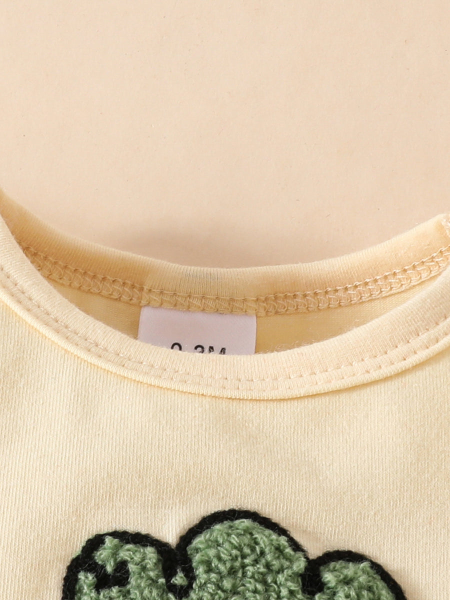 Yellow baby bodysuit with charming carrot appliqué detail and size tag
