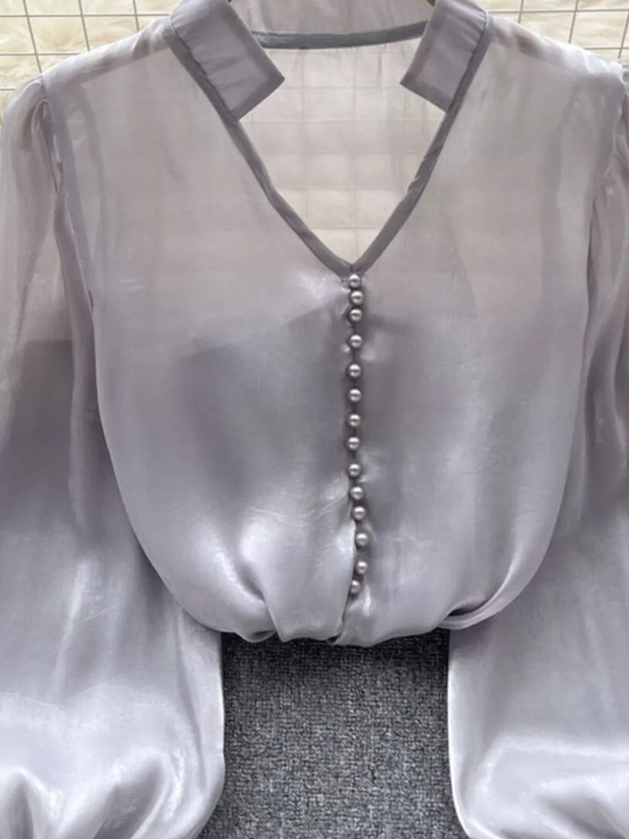 Gray sheer button-down shirt with pearl buttons and V-neckline