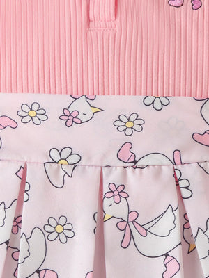Blush pink ribbed polo top with a pleated skirt featuring a duck and flower print.
