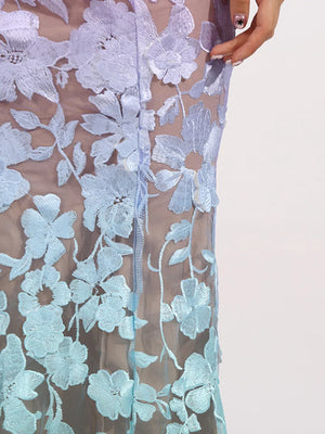 Sheer lace dress with floral embroidery in gradient blue and lavender tones.