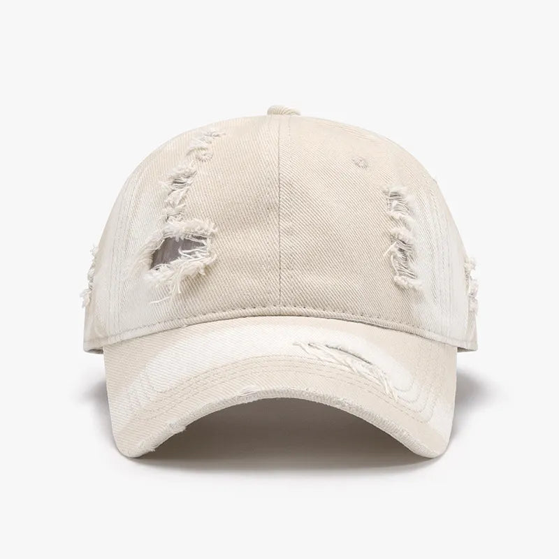 Shredded canvas baseball cap in ivory with distressed details and curved brim.
