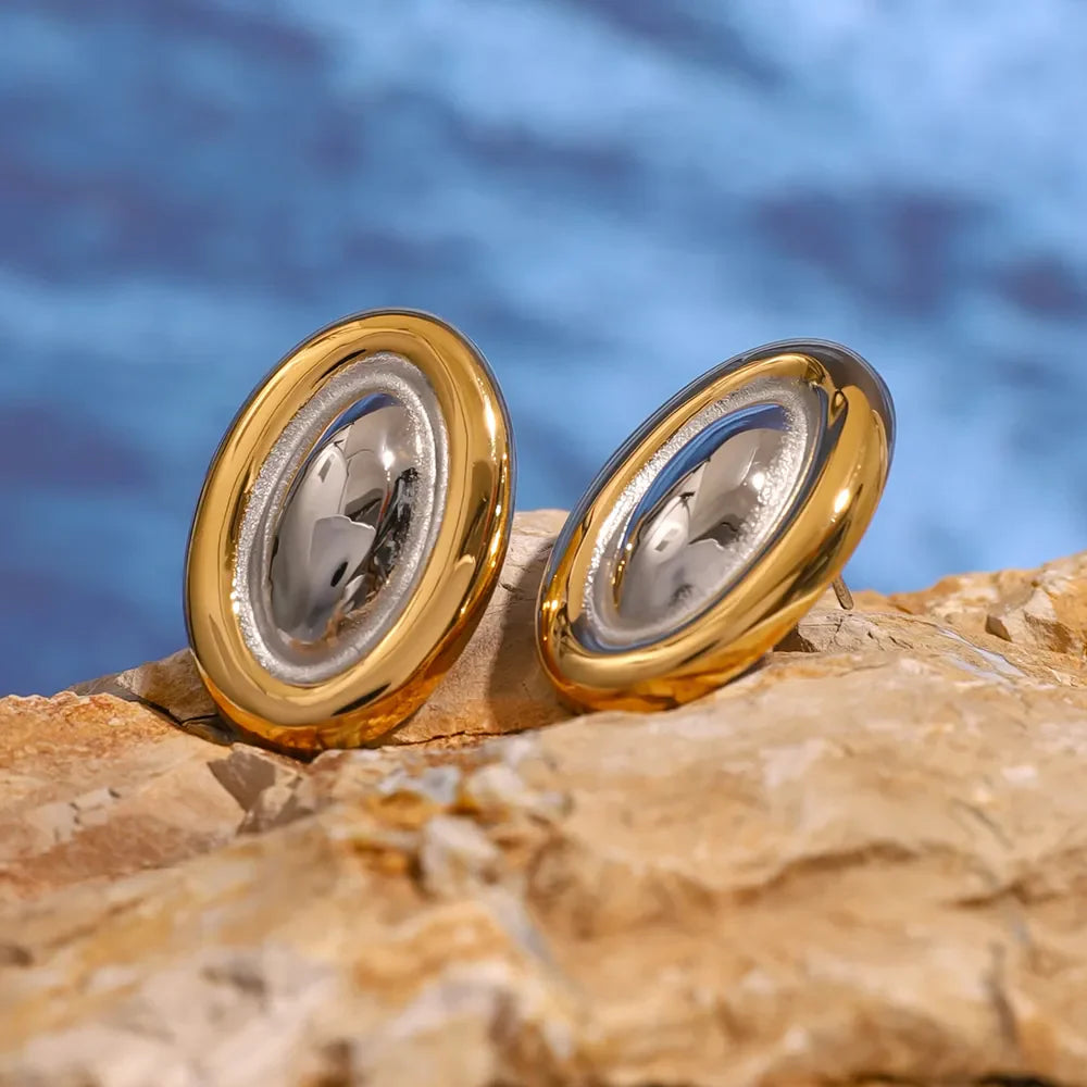 Two-tone gold oval statement earrings with a polished finish.