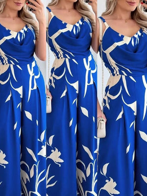 Royal blue abstract leaf print wide-leg jumpsuit with cowl neck and adjustable straps.
