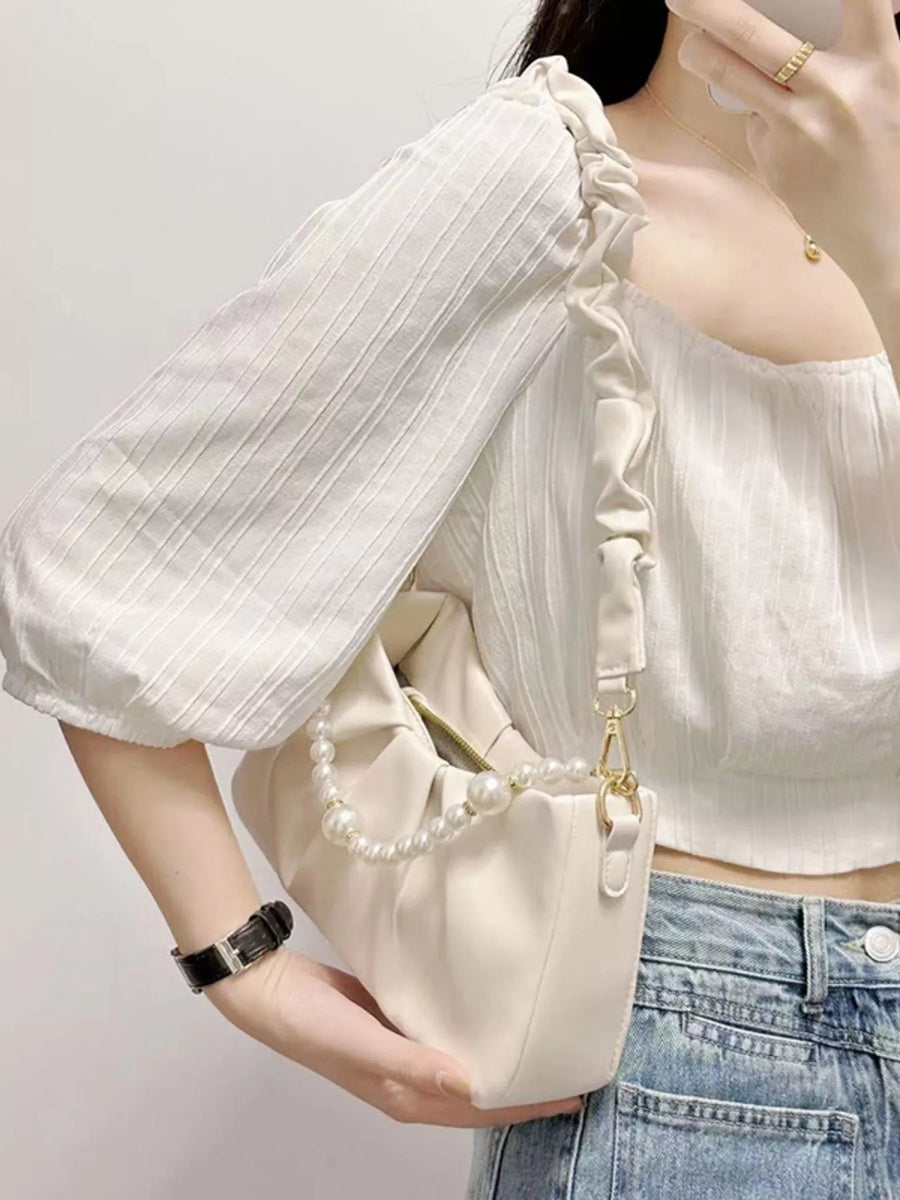 Beige ruched shoulder bag with pearl strap detail