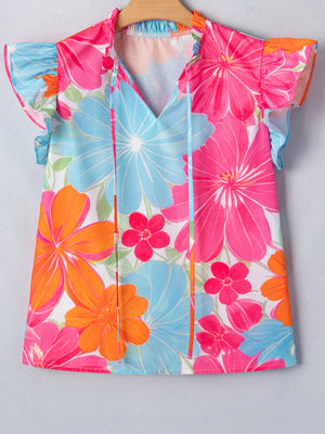 Tie neck blouse with bright floral print, flutter sleeves, and V-neck.