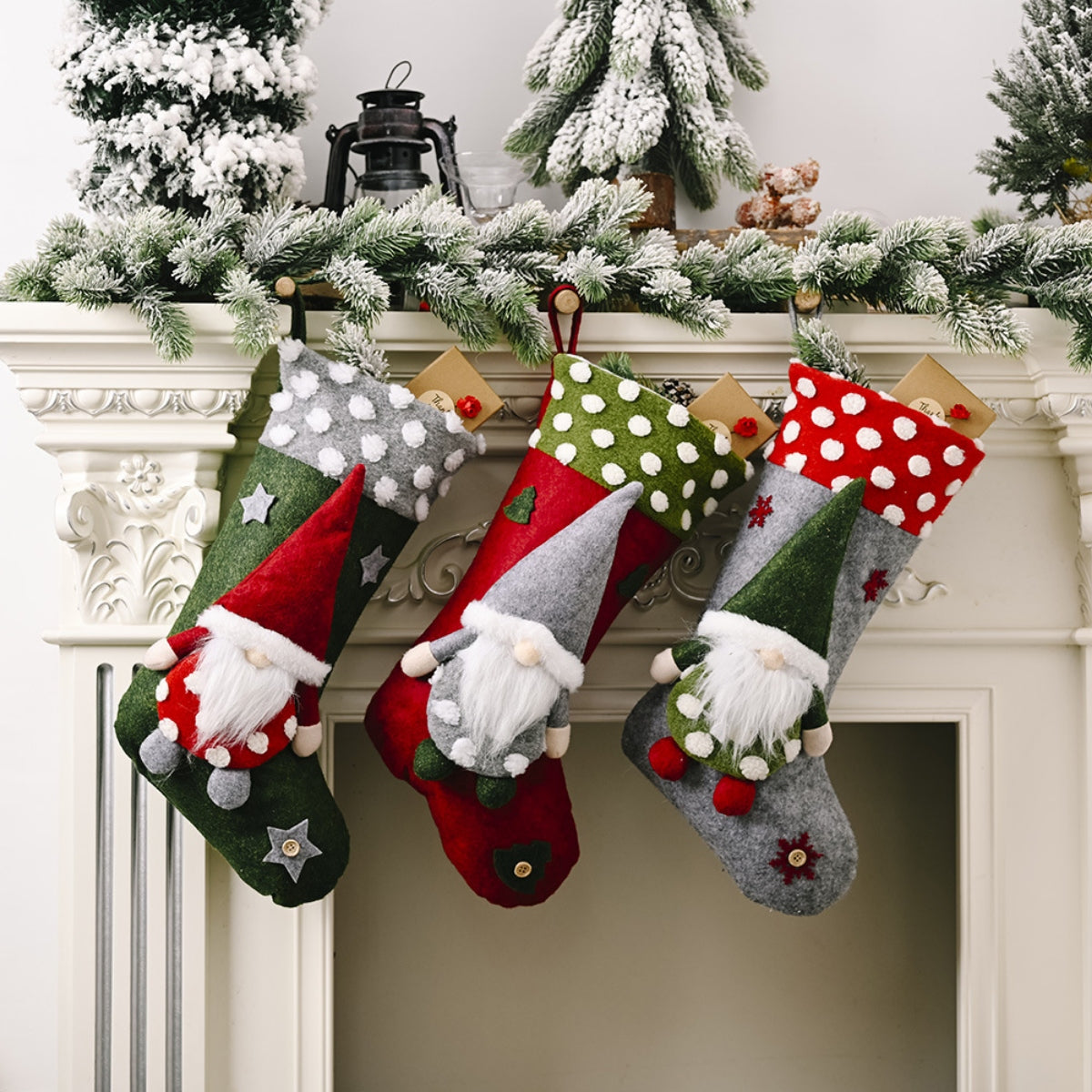 Gnome-adorned felt Christmas stockings in red, green, and gray with polka dot and star details.