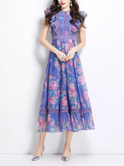Purple floral midi dress with ruffle sleeves, lace trim, and a tiered hem.