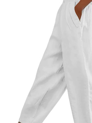 White maternity wide-leg pants with pockets, showing a relaxed fit and comfortable fabric.