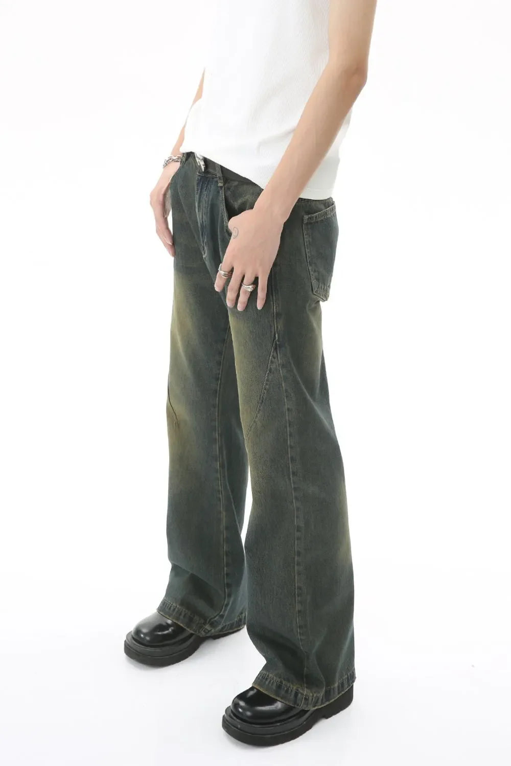 Faded wash flare denim trousers in dark, with a relaxed fit and distressed details.