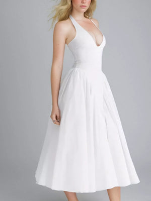 Elegant white halter neck midi dress with deep V-neck and full skirt.