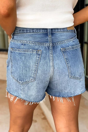 High-waisted denim shorts in light blue wash with frayed hem and distressed details.