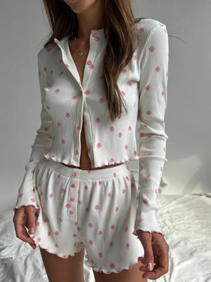 White floral print knit lounge set with button-front top and shorts, featuring frill trim.