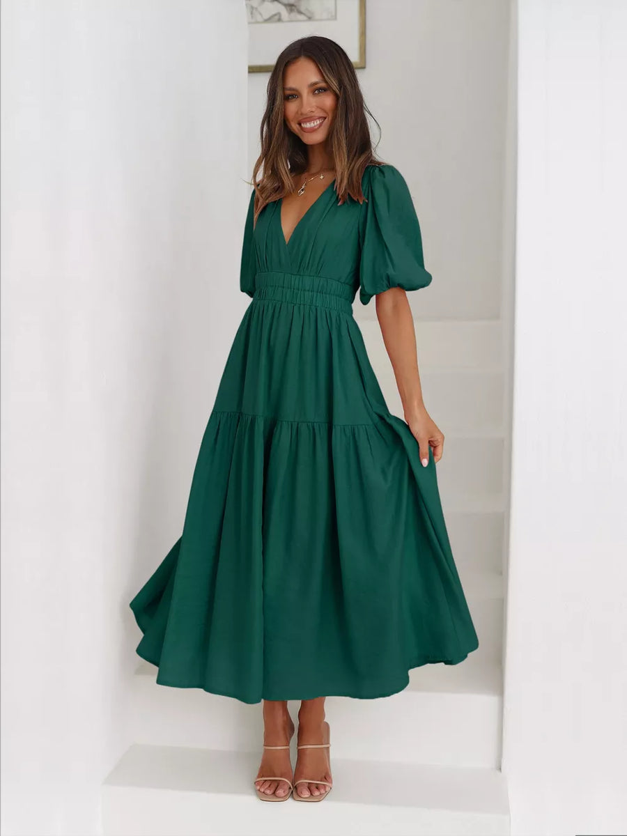 Dark green midi dress with puff sleeves, V-neck, and tiered skirt.