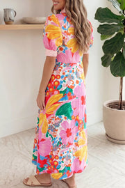 Maxi dress with vibrant floral print, puff sleeves, and striped cuffs.