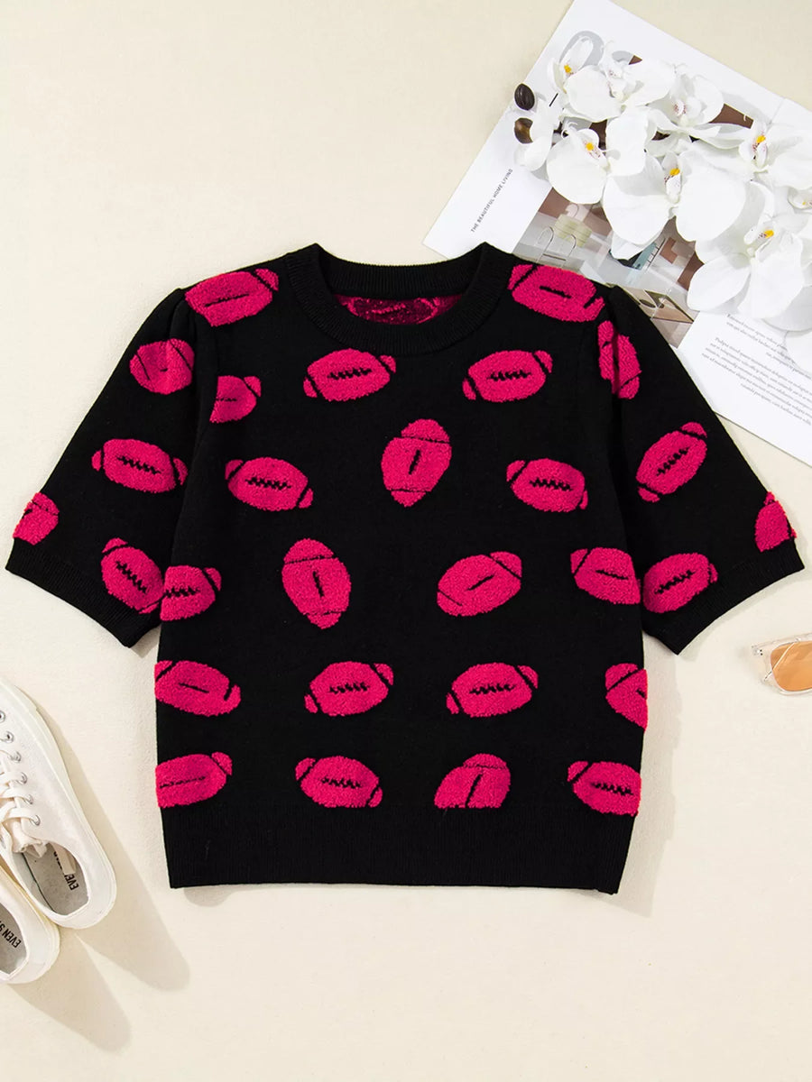 Black short-sleeve knit sweater with a playful pink football pattern.