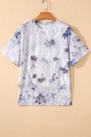 Crew neck t-shirt with a faded camouflage leaf print in purple and blue tones.