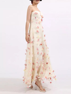Strapless ivory tulle maxi dress with floral appliques and sweetheart neckline.