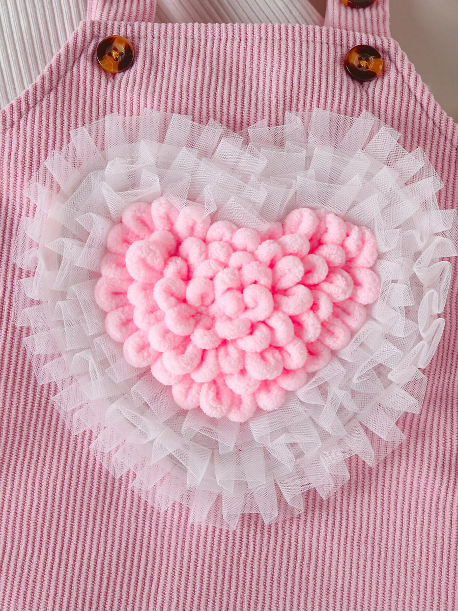 Blush pink corduroy baby dress with white tulle trim and fluffy pink heart applique.