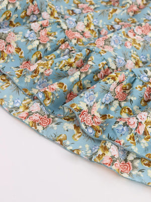 Vibrant floral mini dress with ruffled hem and deep v-neck detail.