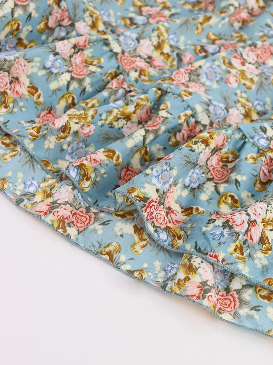 Vibrant floral mini dress with ruffled hem and deep v-neck detail.
