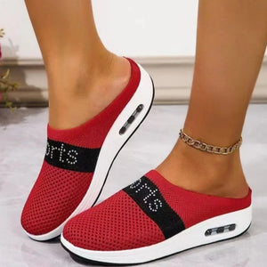 Red mesh slip-on athletic shoes with air cushion and "SPORTS" detail