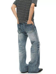 Men's light wash denim flare jeans with distressed details and a relaxed fit.