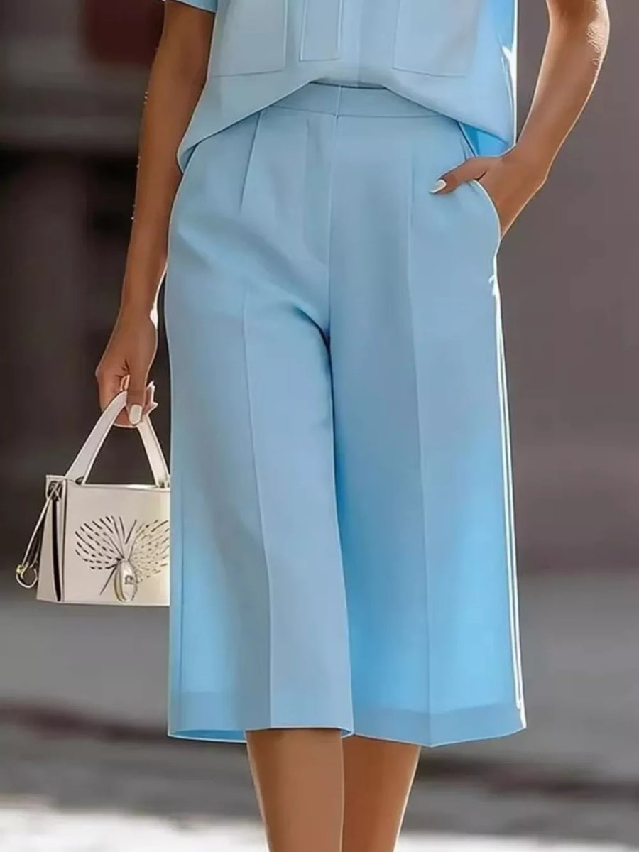 Sky blue two-piece set with wide-leg culotte pants featuring pockets and a matching top.