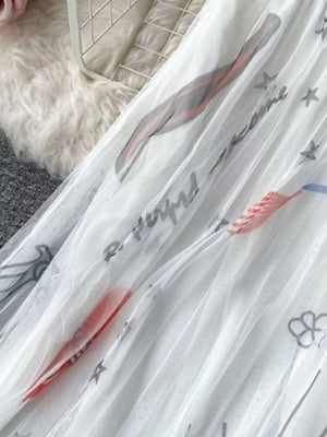 White tulle skirt with abstract sunburst print and text details.