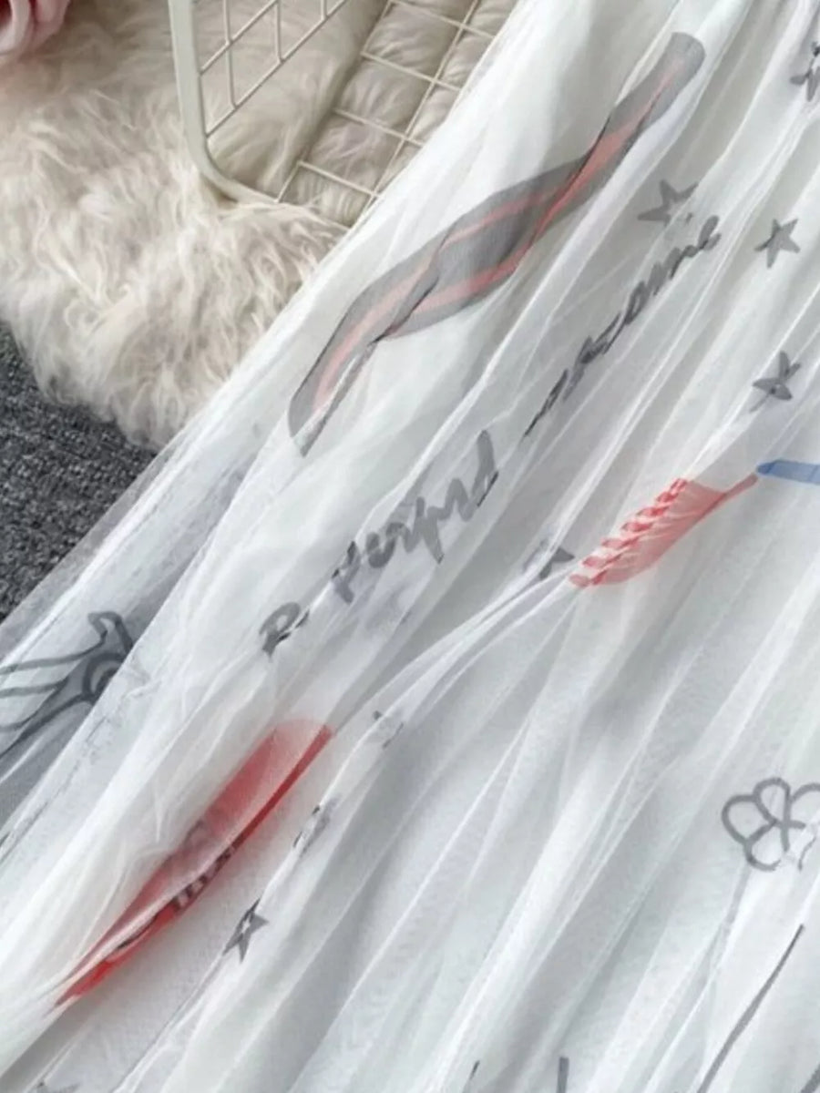 White tulle skirt with abstract sunburst print and text details.