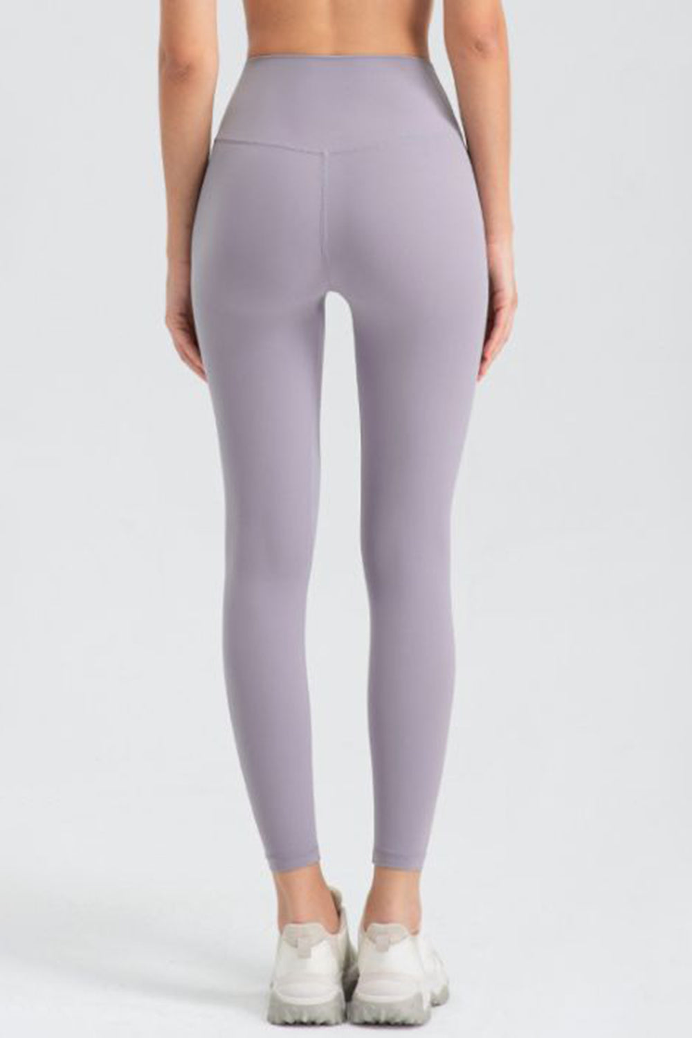 Lavender high-waist performance leggings with sculpted seams and a V-shaped back detail.