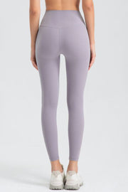 Lavender high-waist performance leggings with sculpted seams and a V-shaped back detail.