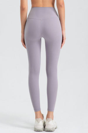 Lavender high-waist performance leggings with sculpted seams and a V-shaped back detail.