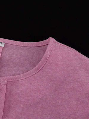 Pink cotton blend henley shirt with a rounded neckline and short sleeves.