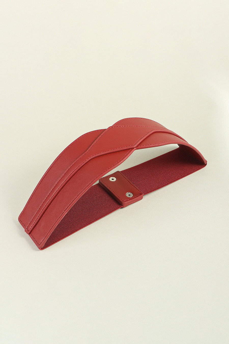 Burgundy elastic belt with sculpted faux leather front and snap closure