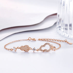Rose gold bracelet with gourd charms and cubic zirconia accents, adjustable chain.